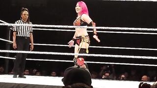 Becky taking a deep stinkface from Asuka!